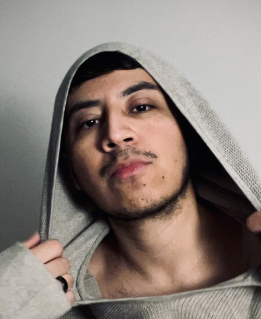 Edu Hernandez wearing a hooded sweatshirt